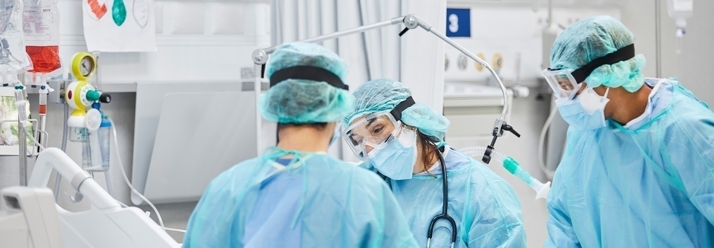 doctors in PPE performing a surgery